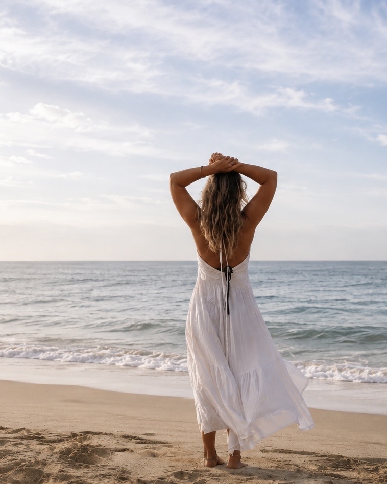 A person walking by the sea at golden hour